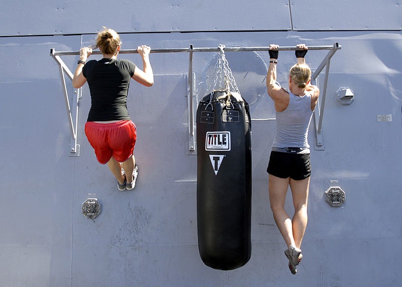 two women doing pull ups