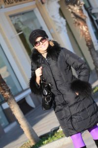 fashionable woman with coat, sunglasses and hat