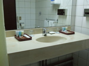 bathroom mirror, sink and faucet