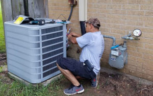 air conditioning professional servicing a home unit