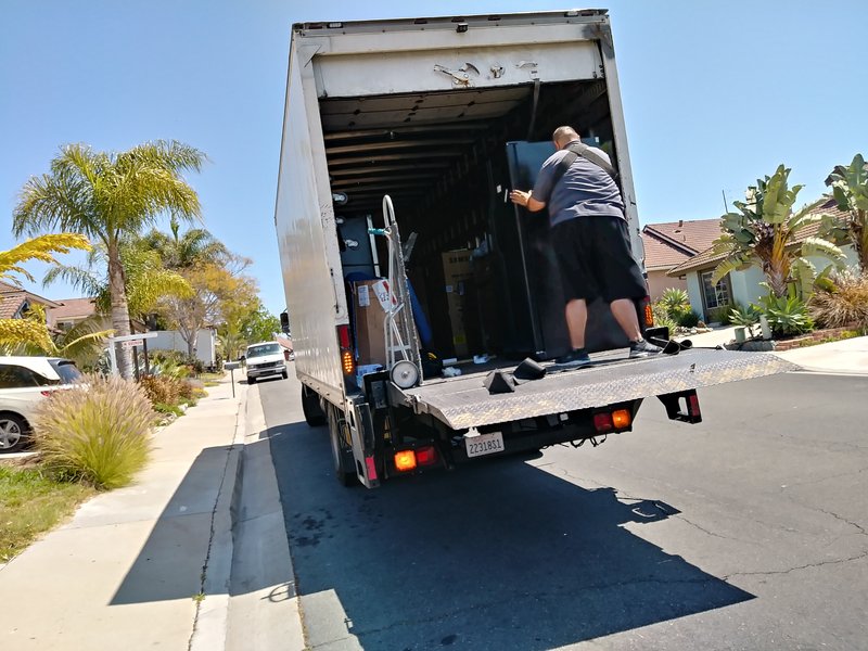 mover moving items into moving truck