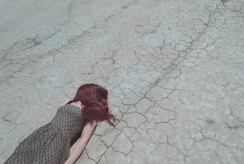 woman lying down on the road