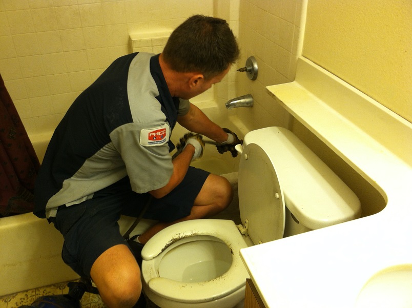 plumber fixing bathroom drain